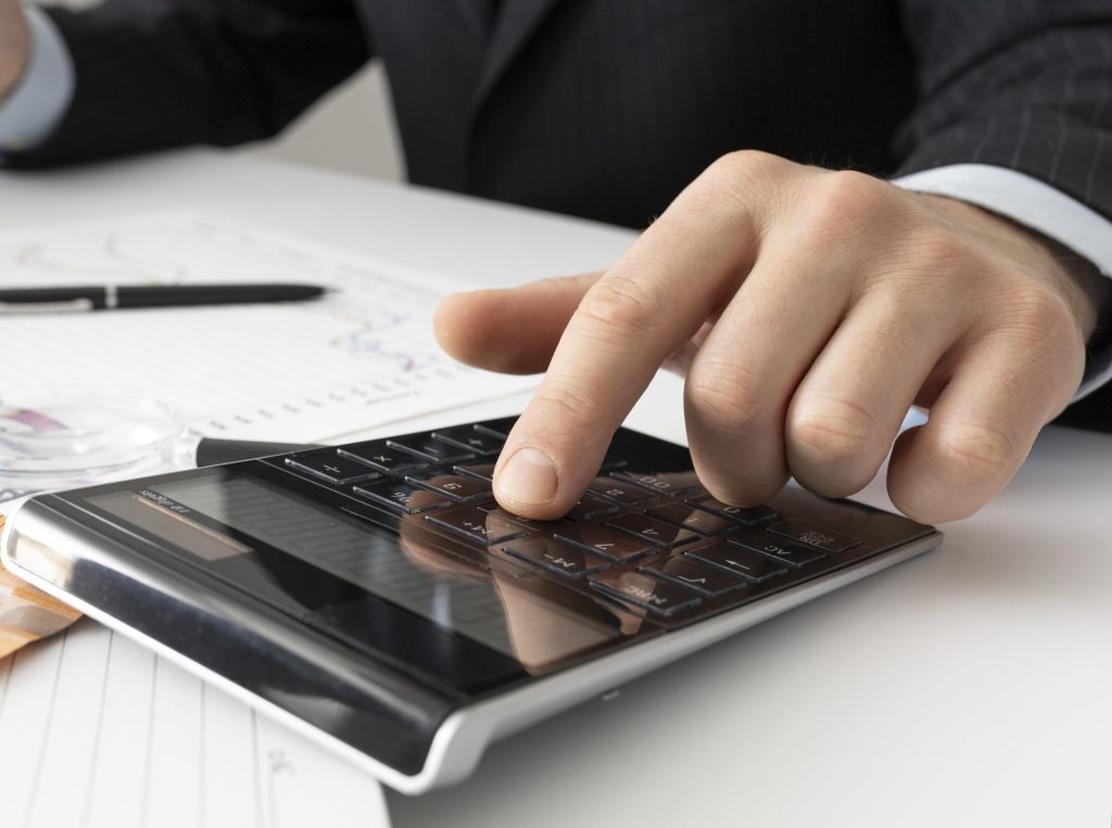 Homem digitando na calculadora